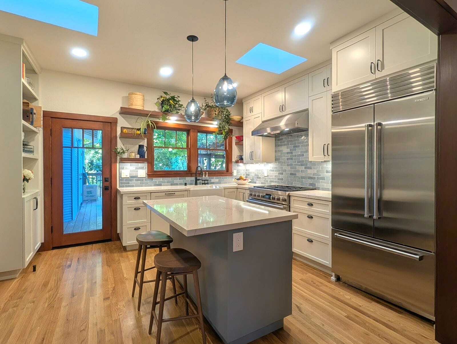 This contemporary two-toned, cottage kitchen remodel blends timeless design with modern functionality. The space was reimagined to highlight natural light and comfort while incorporating thoughtful design details that make everyday living delightful.